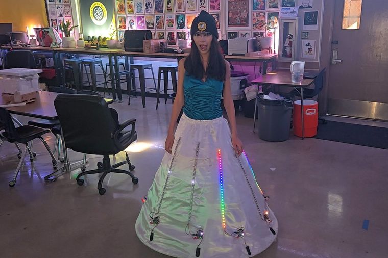 A student wearing a floor-length gown lit with addressable LEDs