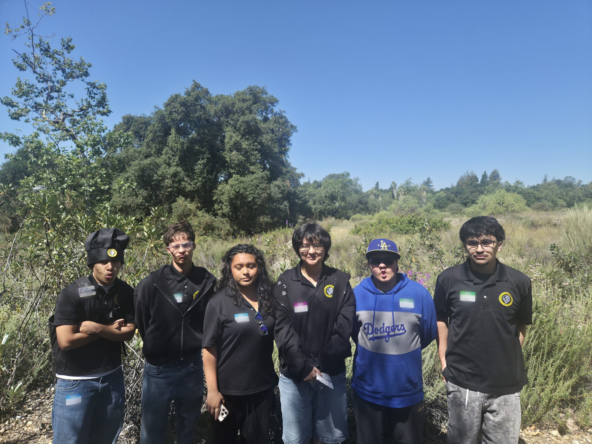 Students standing in open ground at the Bernard Field Station during the woodrat survey