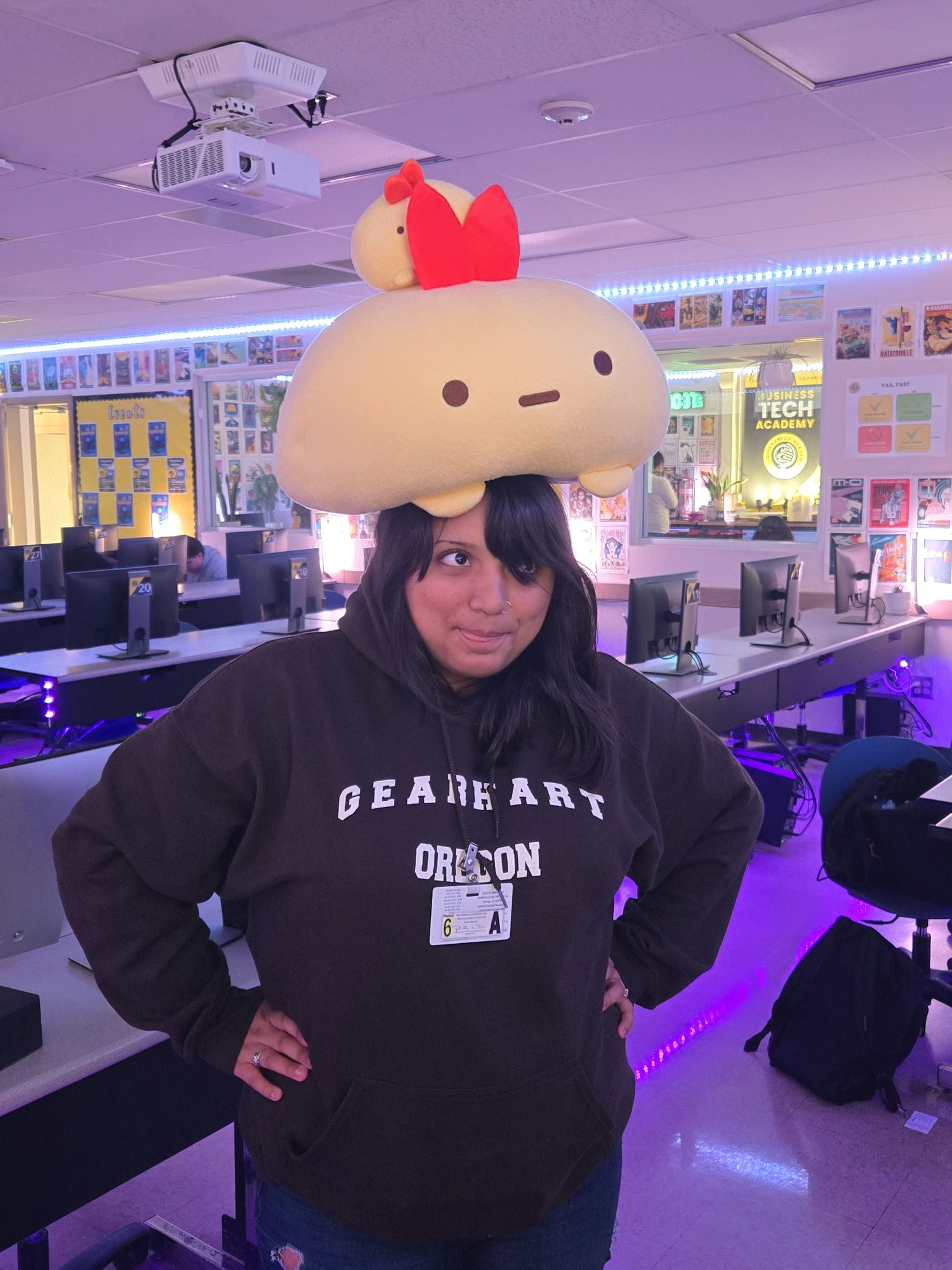 A student in the Academy room with a Sumikko Gurashi plush balanced on her head